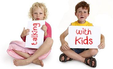children sitting and holding signs that say